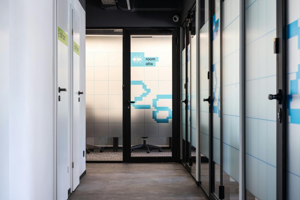 Contemporary office corridor with glass doors and modern design elements.
